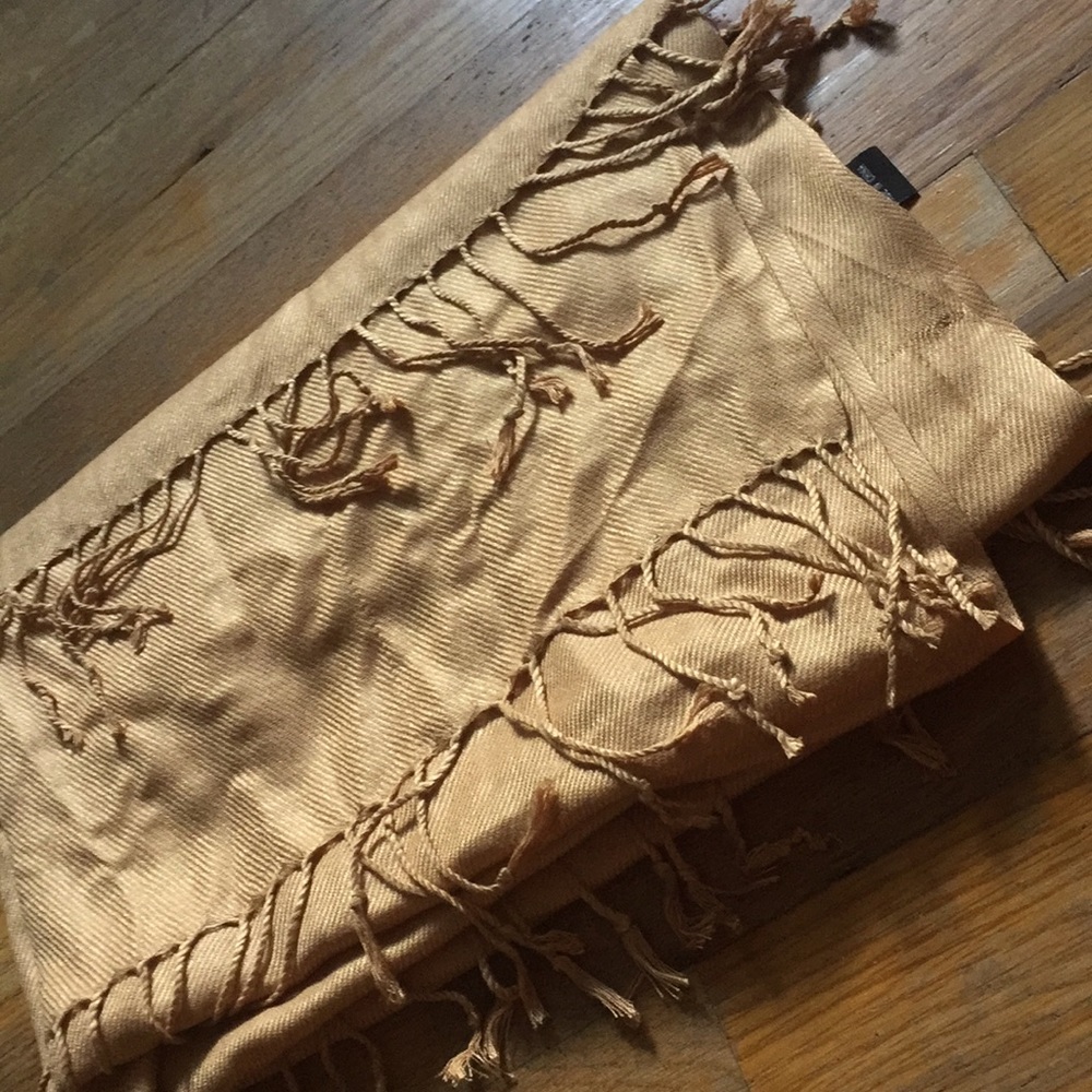 Gold colored shawl with fringes.